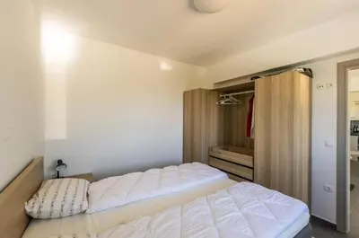 a bedroom with a large white bed in it at Kayzo Luxury Apartment With Pool in Tavronitis