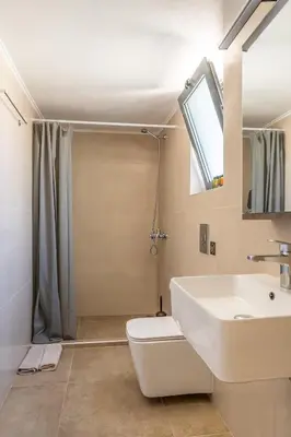 a bathroom with a sink and a toilet and a shower at Myra city House in Chania Town