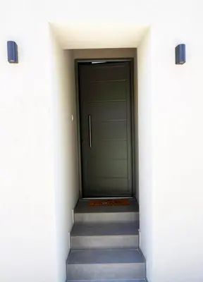 a hallway with stairs leading to a door at Olgas cozy home in Chania Town