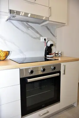 a kitchen with a stove top oven in a kitchen at Olgas cozy home in Chania Town