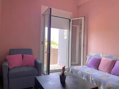 a living room with a couch and a table at Souda Bay in Souda