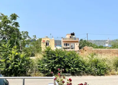 a house sitting on top of a hill with plants at Souda Bay in Souda