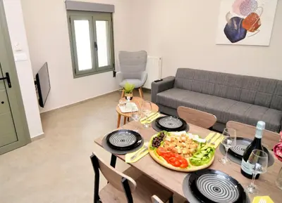 a living room with a table with a plate of food at Manolis cozy home in Chania Town