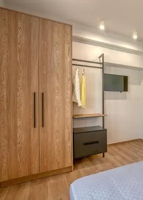 a bedroom with wooden cabinets and a bunk bed at Alyona Villas - Villa Lona in Skinés