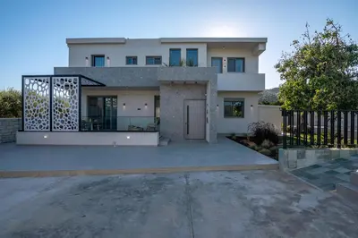 a large white house with a large driveway at Alyona Villas - Villa Lona in Skinés