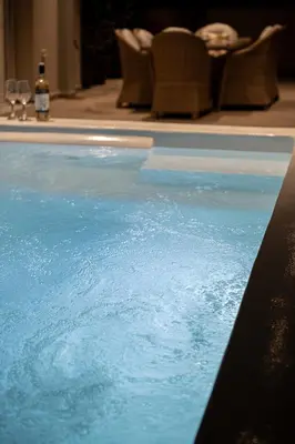 a swimming pool with blue water in a room at HappyHouse Villa in Kissamos