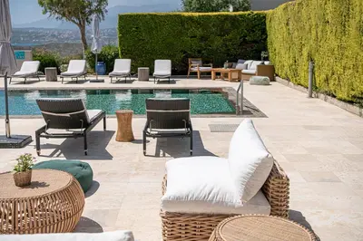 a patio with chairs and a pool with chairs and tables at Mediterranean villa Seaview privet pool in Tersanas