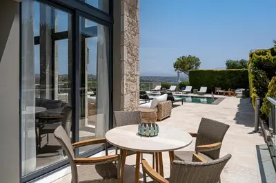 a patio with chairs and a table on a patio at Mediterranean villa Seaview privet pool in Tersanas