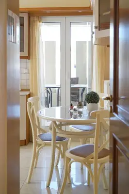 a kitchen and dining room with a table and chairs at Kostoula's House Beachfront in Stalos
