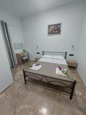 a bedroom with a bed with flowers on it at Maria's sala in Kissamos