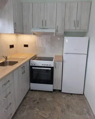 a kitchen with a white stove and a refrigerator at Maria's sala in Kissamos
