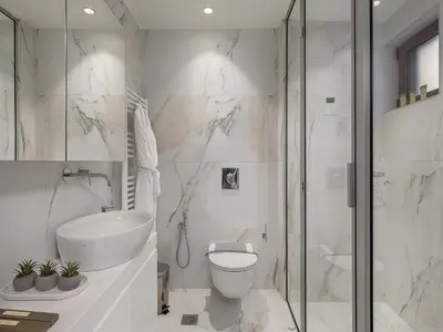 a bathroom with a shower and a toilet and a sink at Elia Seaside Deluxe Apartment in Chania Town