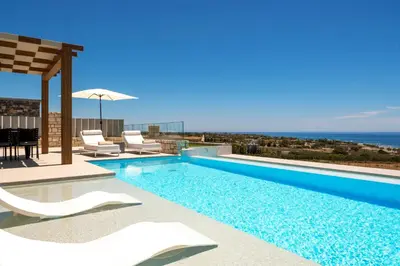 a swimming pool with a view of the ocean at FYSIOPHYLIA VILLAS in Frangokastello