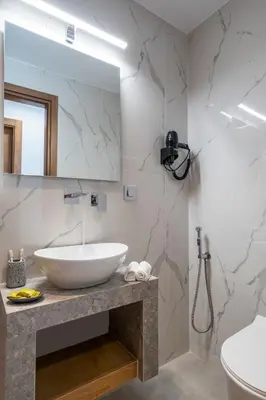 a bathroom with a white sink and a mirror at FYSIOPHYLIA VILLAS in Frangokastello