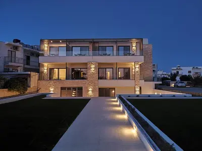 a large building with lights in front of it at Ammos Paleochora Hotel in Palaiochóra