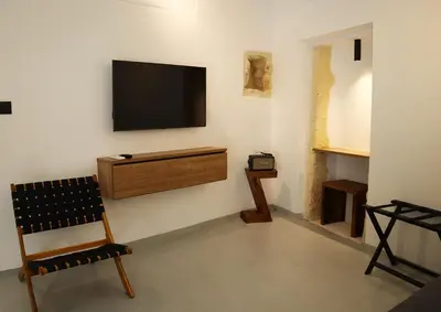a living room with a television on a wall at Porto 57 in Chania Town