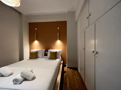 a bedroom with two beds with towels on them at ZEN central flat with seaview by 8essentially in Chania Town