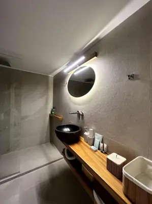 a bathroom with a black sink and a mirror at ZEN central flat with seaview by 8essentially in Chania Town