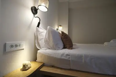 a bedroom with a bed with a lamp on it at ZEN central flat with seaview by 8essentially in Chania Town
