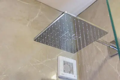 a metal airplane hanging from the ceiling of a bathroom at Anna Boutique Apartment in Kato Daratso