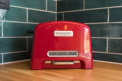 a red toaster sitting on top of a table at Anna Boutique Apartment in Kato Daratso