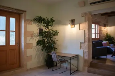 a living room with a table and a plant at Amygdalia Traditional House in Chania Town