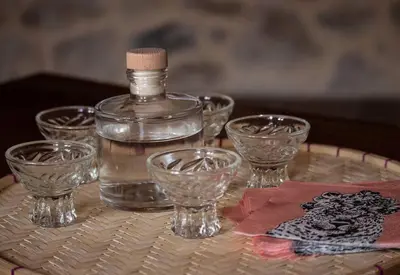 a bottle of water and glasses on a table at Amygdalia Traditional House in Chania Town