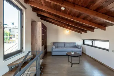 a living room with a couch and a table at Dioni by PosarelliVillas in Kounoupidhianá