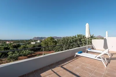 a villa with a view of the ocean on a balcony at Aelia by PosarelliVillas in Kounoupidhianá