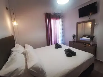 a hotel room with two beds and a mirror at Erofili central apartment in Chania Town