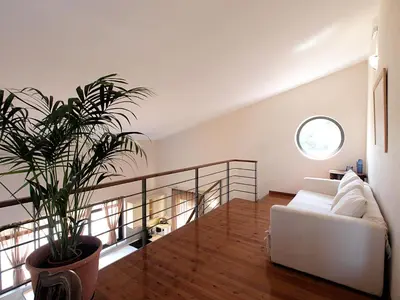 a living room with a couch and a potted plant at VILLA ROTUNDA B in Chania Town