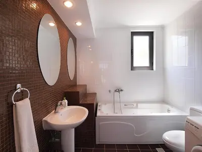 a bathroom with a tub and a sink and a bath tub at VILLA ROTUNDA B in Chania Town