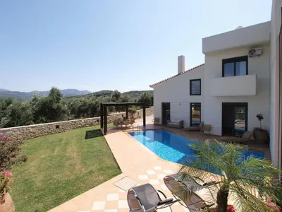 a villa with a swimming pool and a house at VILLA ROTUNDA B in Chania Town