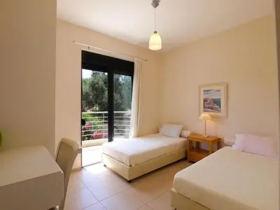 a bedroom with two beds and a window at VILLA ROTUNDA B in Chania Town
