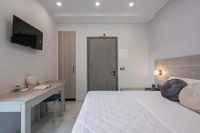 a bedroom with a bed and a desk and a television at Alexia Seaview Apartments in Kissamos