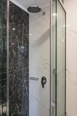 a bathroom with a shower with a glass door at Alexia Seaview Apartments in Kissamos