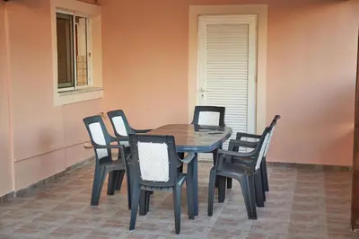 a dining room table and chairs in a room at Sylvias Stylish Apartment in Chania Town