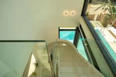 a staircase in a house with a glass wall at Luxury Villa Glass - 200 meters From The Beach no6 in Daratso