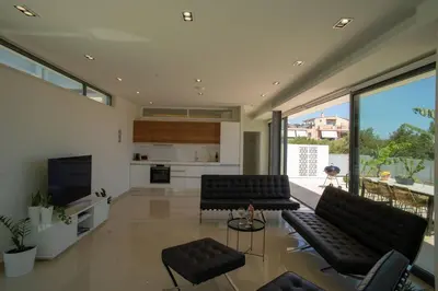 a living room with black leather furniture and large windows at Luxury Villa Glass - 200 meters From The Beach no6 in Daratso