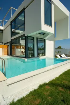 a house with a swimming pool in front of it at Luxury Villa Glass - 200 meters From The Beach no6 in Daratso