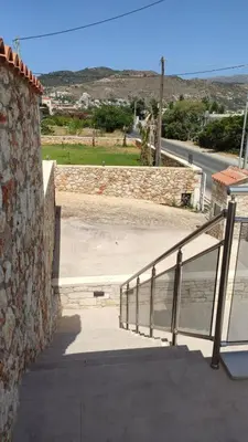 a stairway leading up to a building with a stone wall at Ioanna Apartment 2 in Chania Town