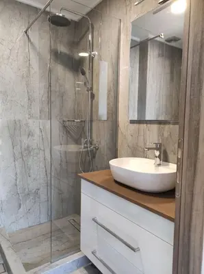 a bathroom with a sink and a glass shower at Ioanna Apartment 2 in Chania Town