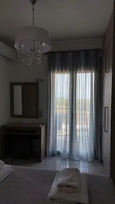 a bedroom with a bed and a large window at Ioanna Apartment 2 in Chania Town