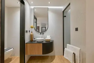 a bathroom with a sink and a mirror at Evridiki Apartment in Chania Town