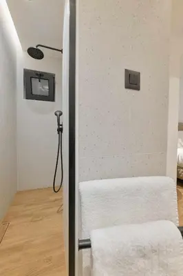 a bathroom with a towel rack and a shower at Evridiki Apartment in Chania Town