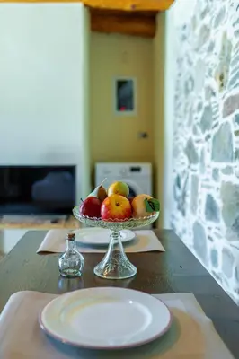 a bowl of fruit on a table with a plate at Plagia Rooms in Kissamos