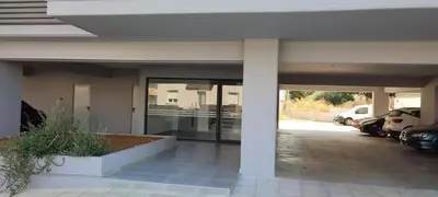 a building with a parking lot with cars parked at Hellene Αpartment near Chania City Centre in Chania Town