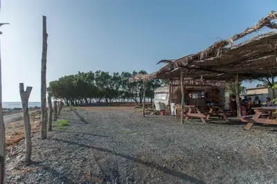 a shack on the beach next to the ocean at Blue Pearl Villa in AmigdhalokeFálion