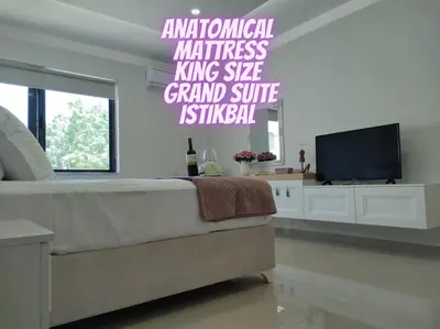 a bedroom with a bed and a flat screen tv at Luxury apartment in the heart of the city in Chania Town