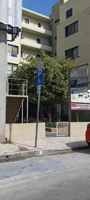a blue parking sign on the side of a street at Luxury apartment in the heart of the city in Chania Town